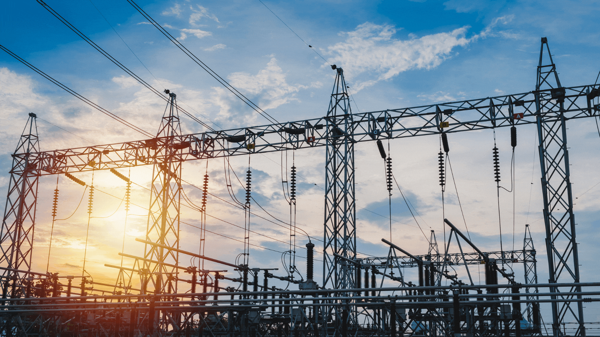High-voltage power lines and poles under professional inspection.